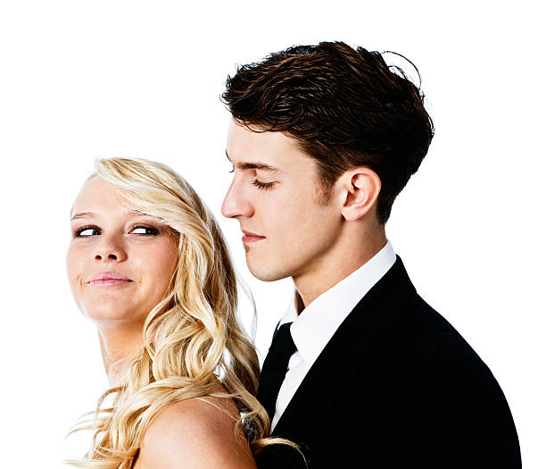 istock Pretty blonde smiling over shoulder at her prom date 174967627