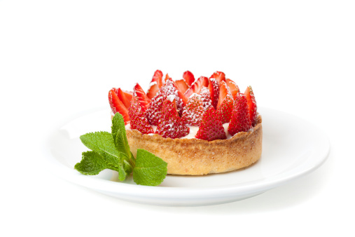 Cheesecake with fresh strawberries on white plate closeupmore images