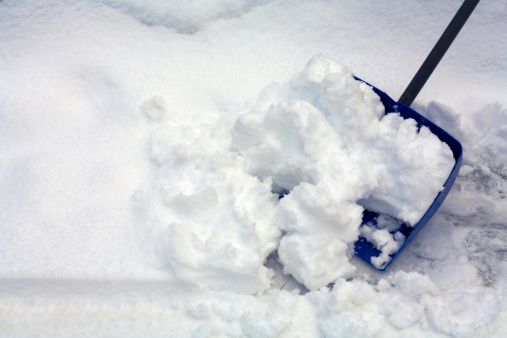 shoveling snow with a blue snow shovel