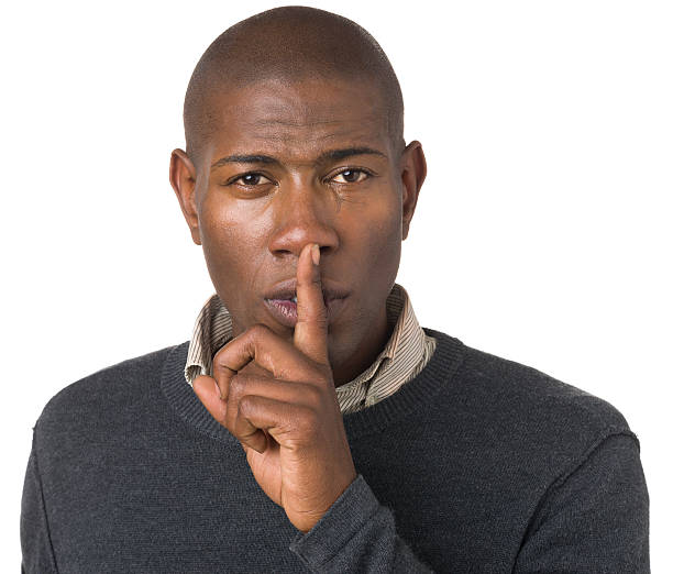 istock Young Man One Finger Quiet Hush Gesture 174968023