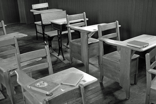 Old classroom student desks in a rural one room schoolhouse... Black and White