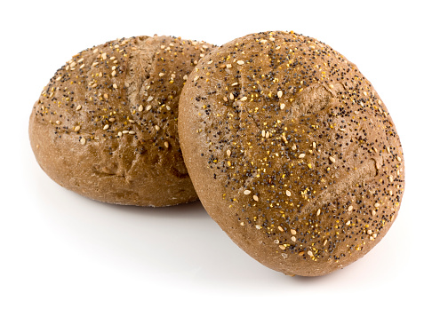 Seeded Wholemeal, whole-wheat or whole-grain brown bread rolls isolated on a white background.