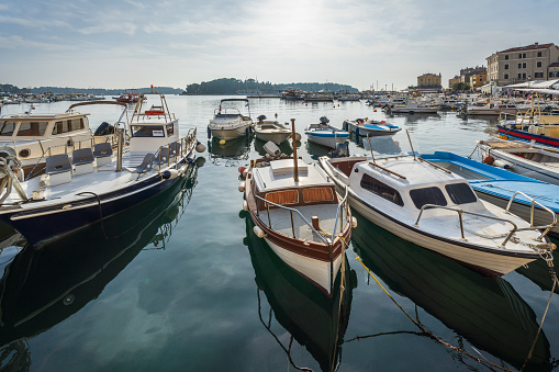 A luxury private motor yacht under way on tropical sea with bow wave