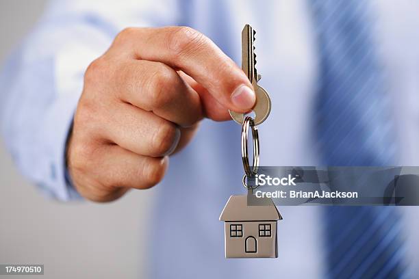 A Man Giving The Key To A House Stock Photo - Download Image Now - Passing - Giving, Key, House