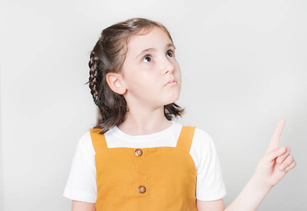 istock Thoughtful little girl looking away thinking 1749709358