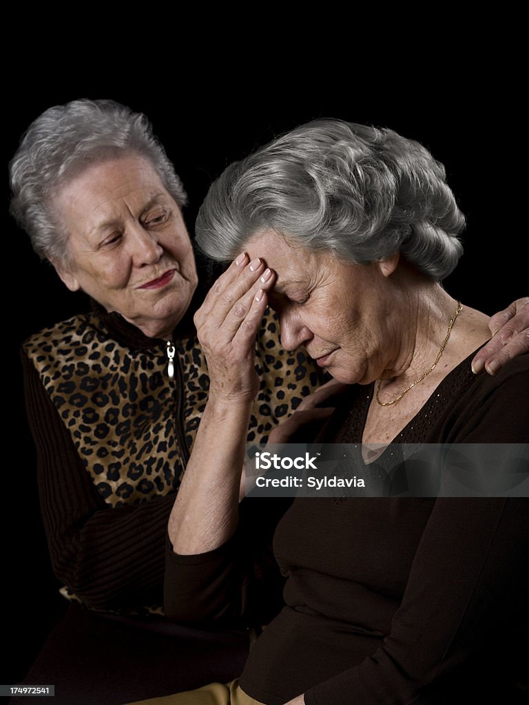 Grief "Portrait of an elderly woman, comforted by her sister" Photography Stock Photo