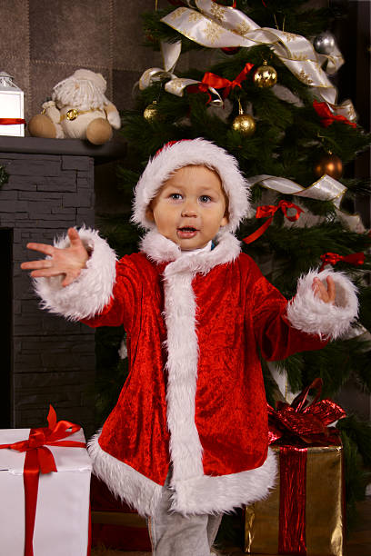 istock baby Santa and Christmas tree 174972626