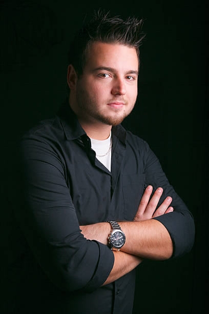 istock Young Man - Arm Cross Black Background 174972687