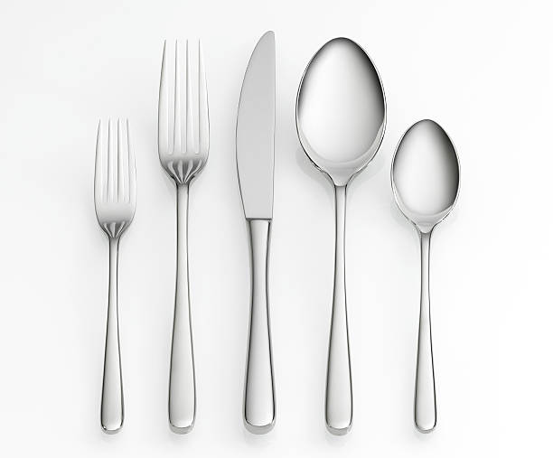 Cutlery set, including knife, forks and spoons Fork, knife and spoon set on white background with clipping path spoon stock pictures, royalty-free photos & images