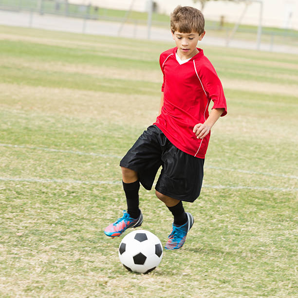 istock Young soccer player preparing to kick ball into goal 174972967