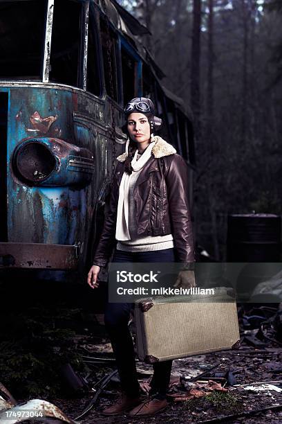 Female Aviator Travels With Suitcase Through Junkyard Stock Photo - Download Image Now