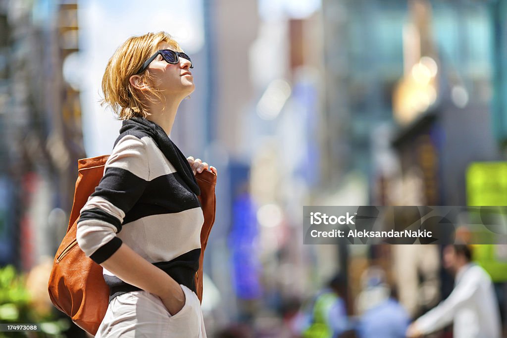 New York City girl with dark specs looking up New York City Girl New York City Stock Photo