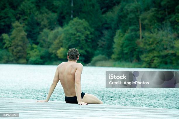 Swimmer Sitting On Jetty Stock Photo - Download Image Now - Adult, Adults Only, Athlete