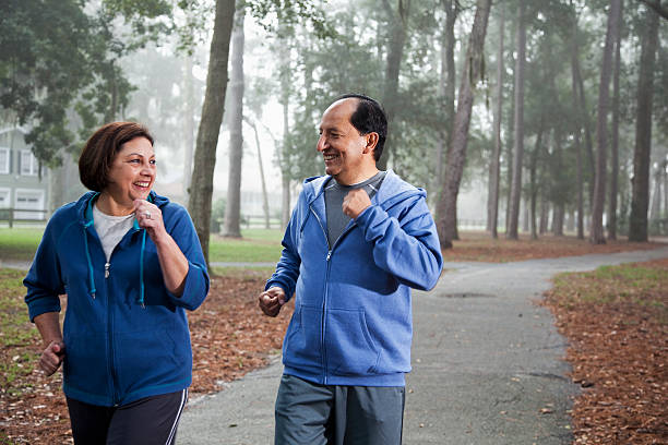 istock Senior Hispanic couple jogging in park 174973449