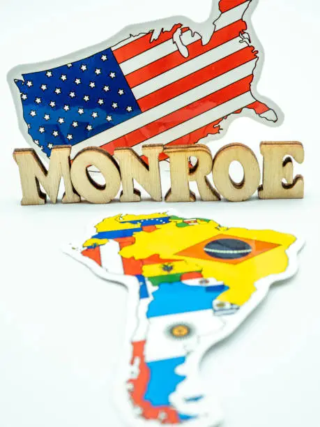 Photo of us flag and map of south america in the foreground, american monroe doctrine concept