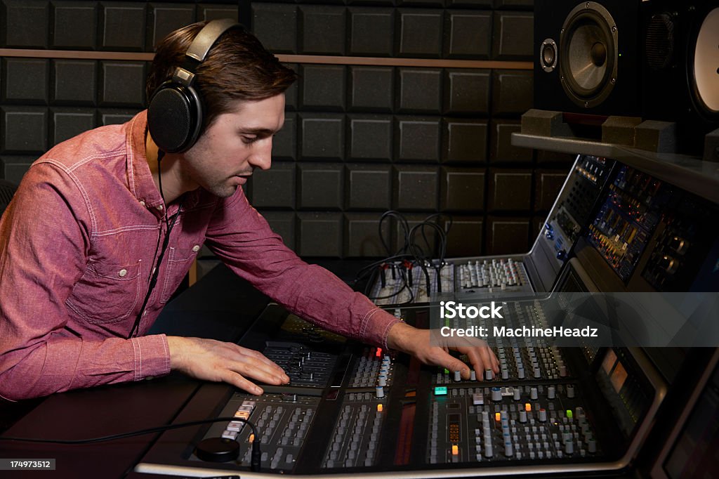 Sound engineer working at mixing desk in recording studio Working with digital recording equipment Technician Stock Photo