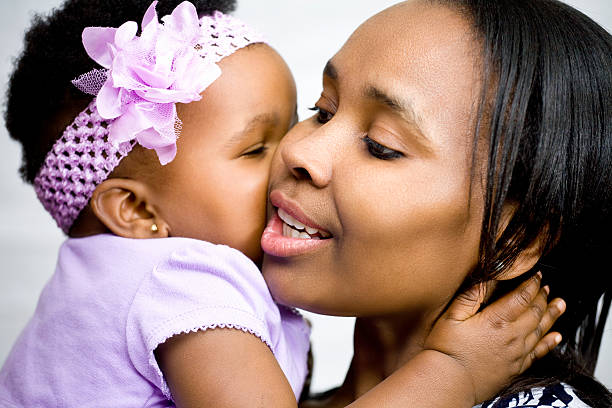 istock Mother and daughter kiss 174974221