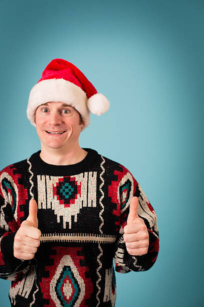 istock Man With Excited Look Wearing Santa Hat and Ugly Sweater 174974549