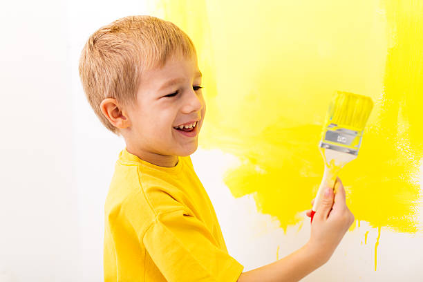 istock Little boy painting the wall 174974566