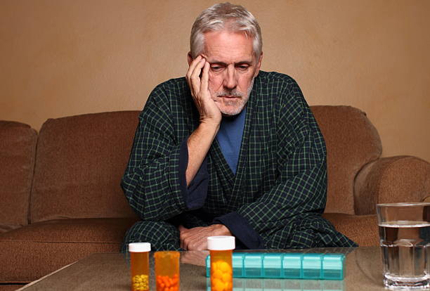 istock Senior Depressed Man Considers Pills Horizontal 174974804
