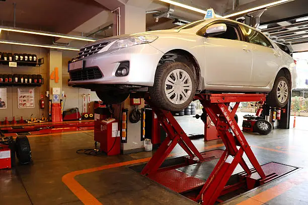 Photo of Car on lift in a repair garage