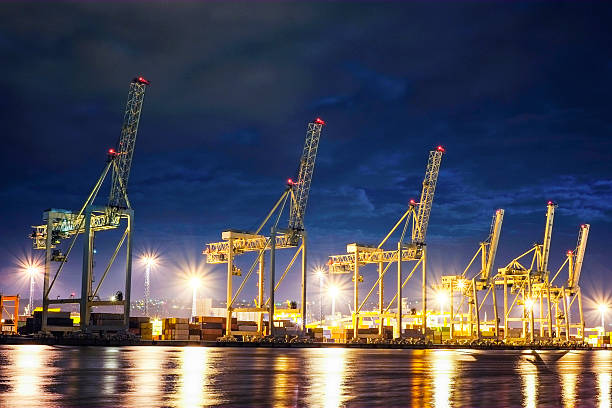 Working cranes in European harbour at night.