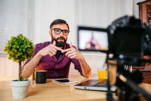 Free Stock Photo of Young Male Vlogger with laptop and camera in office ...