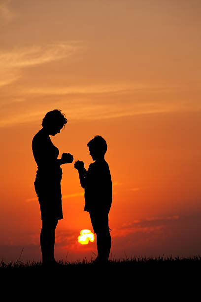 istock Silhouette of Mother and Son Praying 174975438
