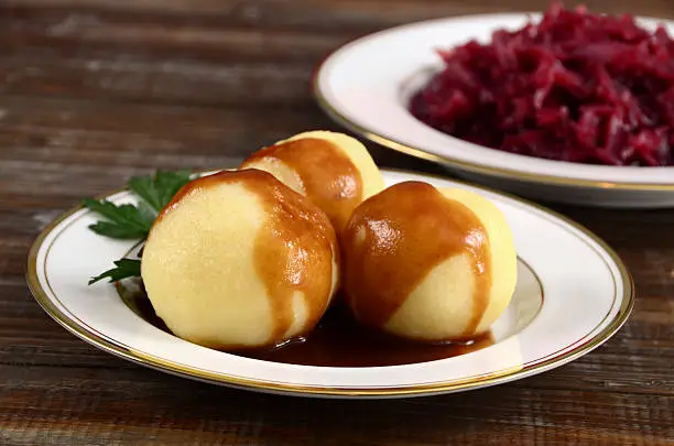 "German (or Austrian) style Knoedel, or potato dumplings, served with gravy and red cabbage."