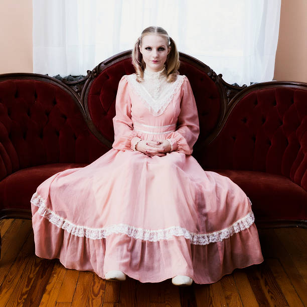 istock Woman In Pink dress Sitting On Sofa. 174975574
