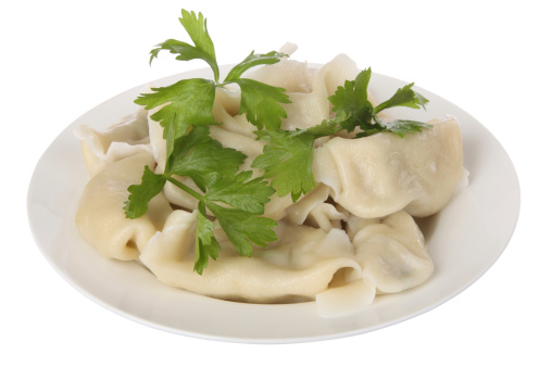 Chinese Dumplings with celery leaves on a plate