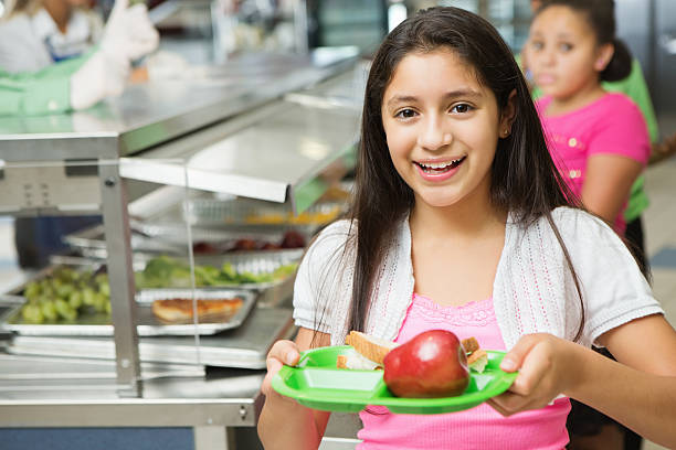 istock Student making healthy choices in school cafeteria lunch line 174976111