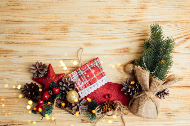 istock Background for greetings with empty space. Christmas toys, stars and pine cones, on a light wooden background 1749761778