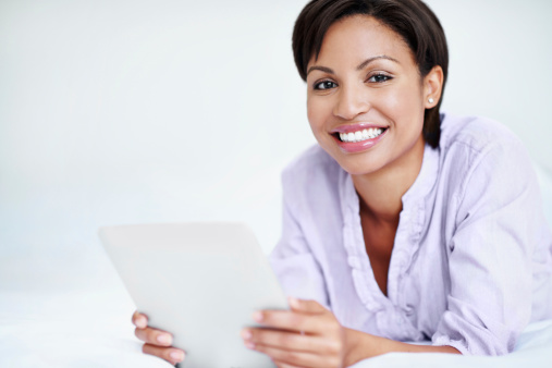 Positive African American woman using her digital tablet at home