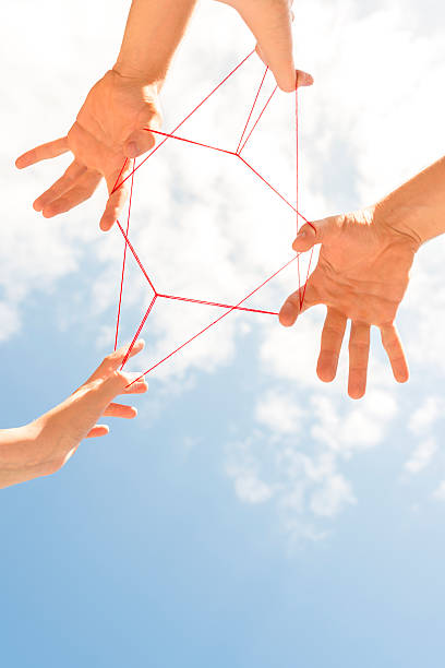 istock Picture of children doing cats cradle from below 174976288