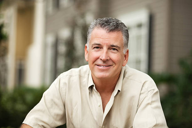 istock Portrait of mature man in a button down shirt smiling 174976372