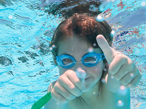 istock Boy (Child) In Swimming Pool Underwater With Thumbs Up 174976387