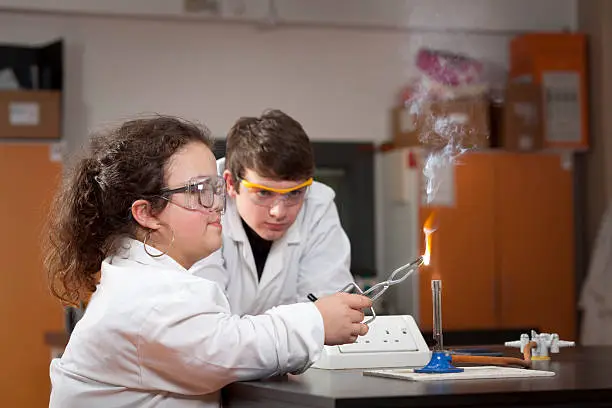 Photo of Science students at school college experiment burning magnesium ribbon