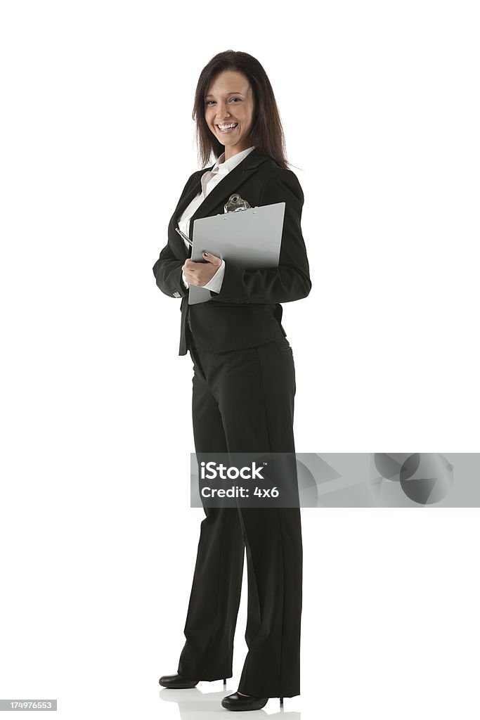 Businesswoman standing with a clipboard 20-29 Years Stock Photo