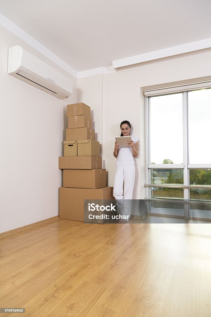 Woman using digital tablet Moving day boxes 25-29 Years Stock Photo