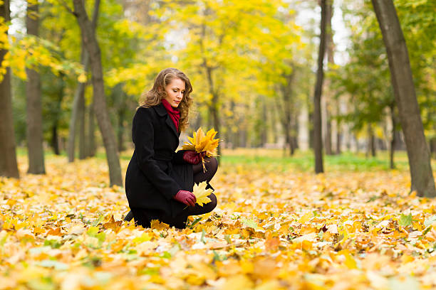 istock Young woman with autumn leaves 174977176