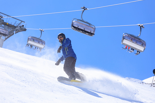 Snowboarding   Man snowboarding  on the mountain ski resort, perfect ski slope.