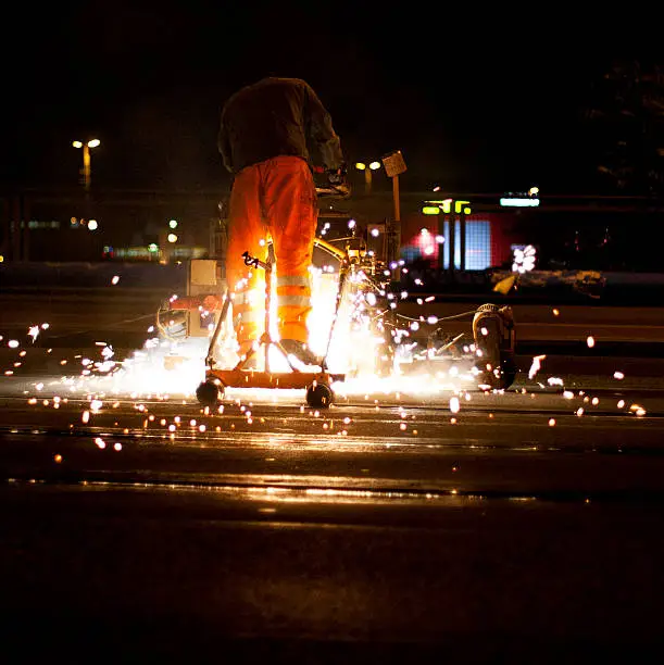 An engineer working on a tramline during the night, Berlin, Germany