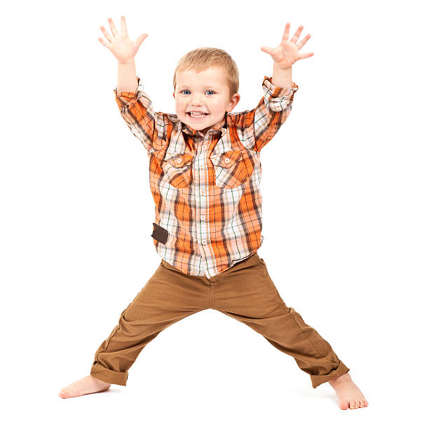 Child playing in chair, dressed in blue and white background, long curly hair, smiling.