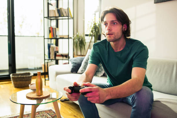 istock Young man having fun playing video games 1749789430