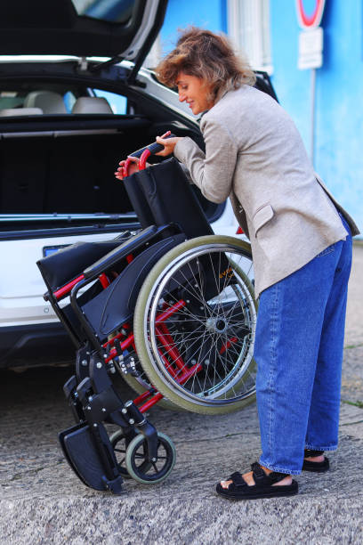 istock Woman folding wheelchair in a car 1749790116