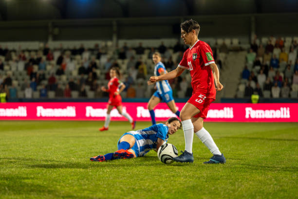 istock Woman soccer player leading ball 1749790128