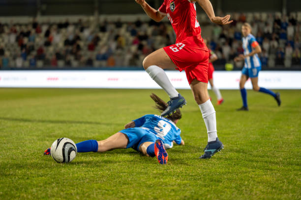 Woman soccer player leading ball