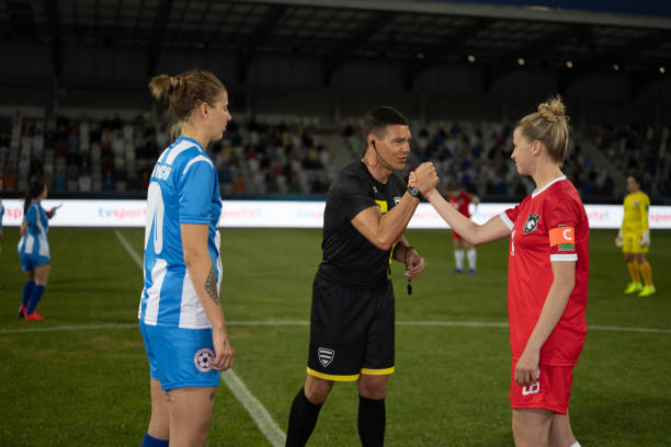 istock Soccer referee shaking hands with teams captains 1749790188