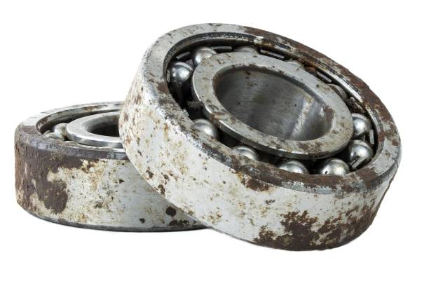 istock Bearing on a white background. Old worn bearing covered with rust 1749790779